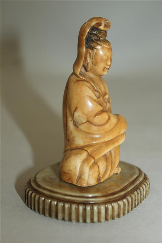 A Chinese soapstone seated figure of Guanyin, 17th / 18th century, 10cm, label for R & V Tregaskis